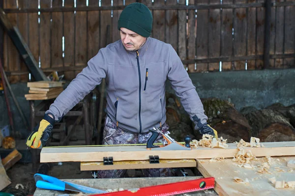 Woodworker measuring and drawing lines on his cabinet project