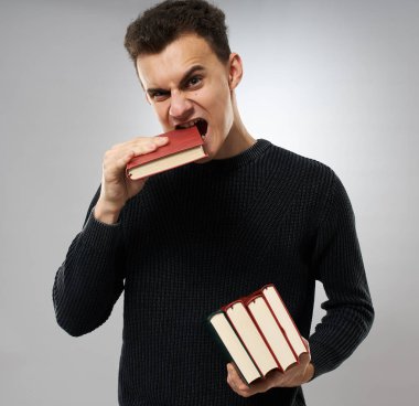 Student with a stack of books, unhappy about the volume of work he has to do clipart