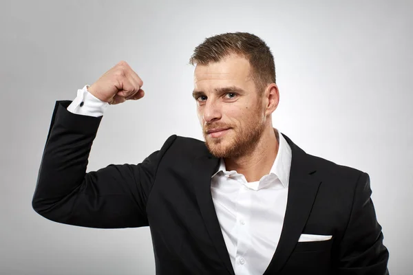 Strong business concept with businessman flexing biceps