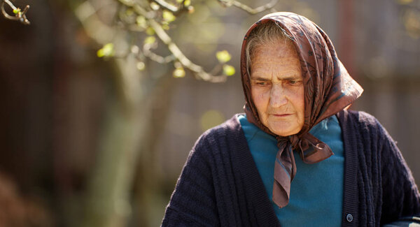 Old rural woman in closeup shot outdoor
