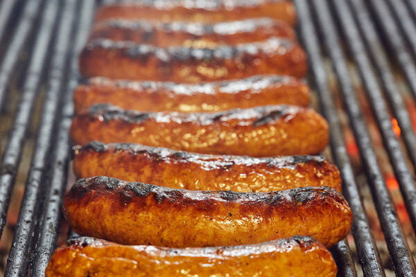 Smoking sausages on the grill in closeup shot