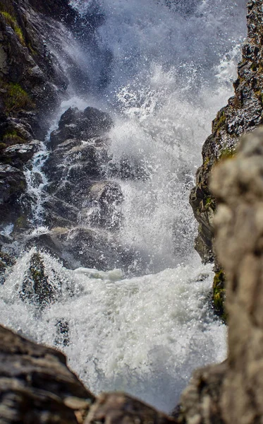 Powerful waterfall in the mountains, late spring early summer