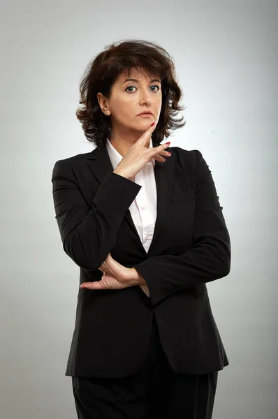 Portrait Pensive Mature Businesswoman Suit Gray Background Stock Photo