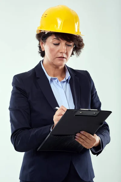 Middle Age Female Engineer Hard Hat Clipboard 스톡 사진