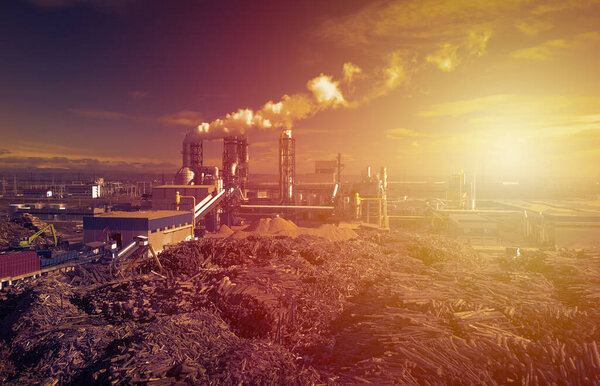 Aerial image of a fuming industrial facility at sunset, industrial pollution concept