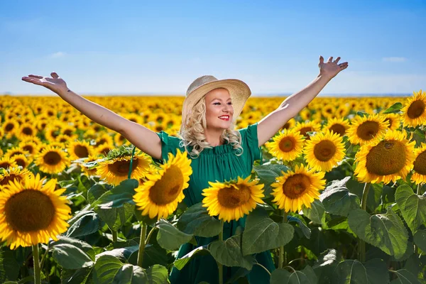 Attractive young woman in a sunflowers field mid summer