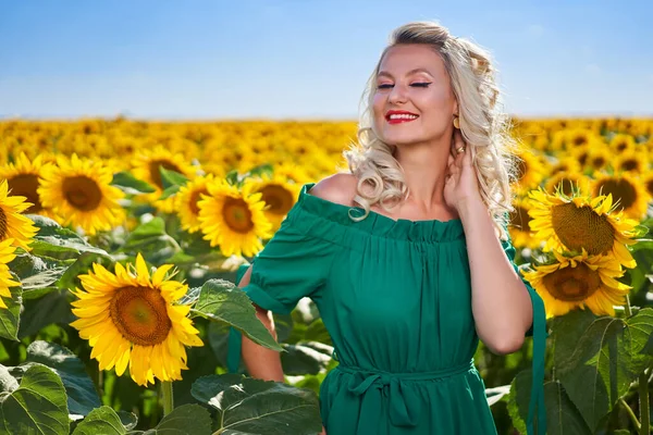 Attractive young woman in a sunflowers field mid summer