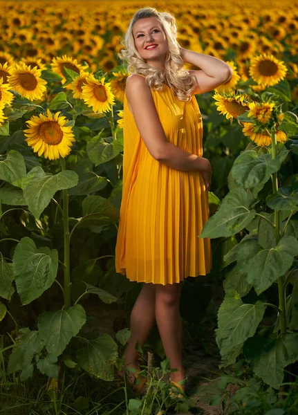 Beautiful blonde Caucasian woman in a sunflower field