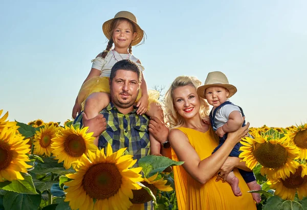 Ung Familj Med Två Barn Som Har Roligt Ett Solrosfält — Stockfoto