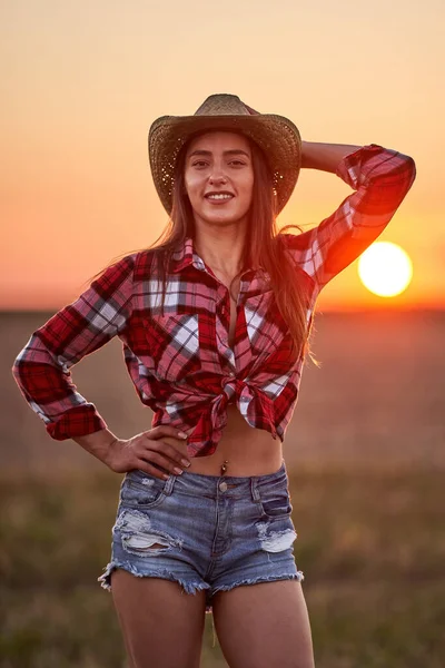 Young Cowgirl Hat Plaid Shirt Blue Jeans Shorts Sunset Field — Stock Photo, Image