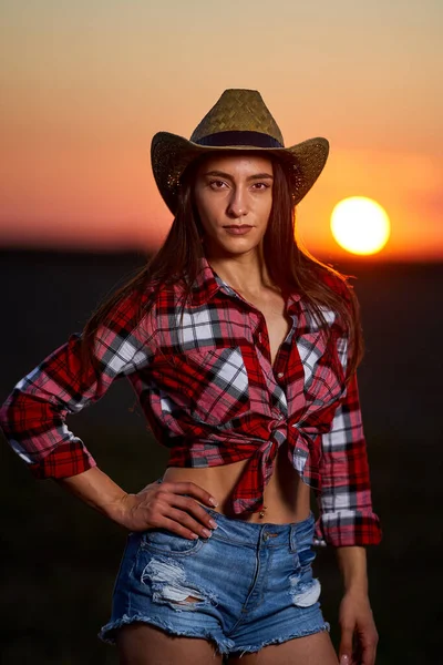 Young Cowgirl Hat Plaid Shirt Blue Jeans Shorts Sunset Field — Stock Photo, Image