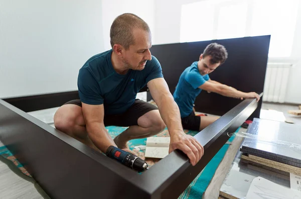 Pai Ajudando Seu Filho Montagem Construir Móveis Sua Nova Casa — Fotografia de Stock