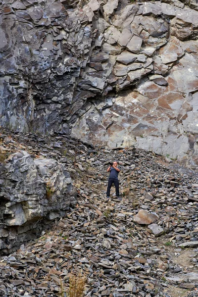 放棄された古代の採石場で様々な種類の岩を記録するプロの写真家 — ストック写真