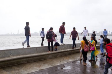 Mumbai, Hindistan - 2 Temmuz 2018: Kimliği belirsiz kişi Güney Mumbai sahil ziyaret. Gezinti nerede insanlar arkadaşlar ve sadece zaman harcamak açık bir alandır.