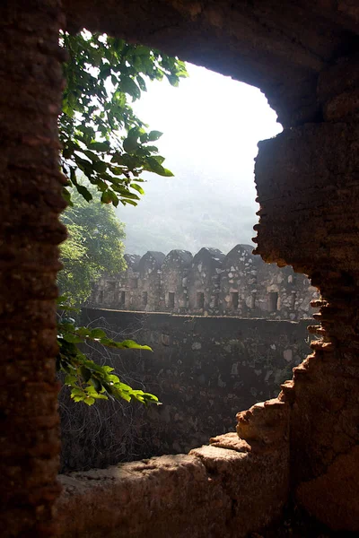 View of fort wall through broken window at Jhansi in Uttar Pradesh, India, Asia