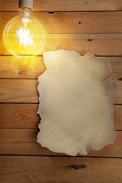 Old Sheet Paper Wooden Table Space Text Light Bulb — Stock Photo, Image