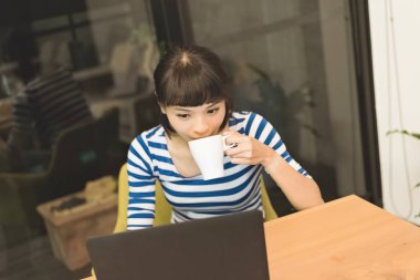 Asyalı kadın geceleri, evde çalışma konsept dizüstü bilgisayar kullanarak