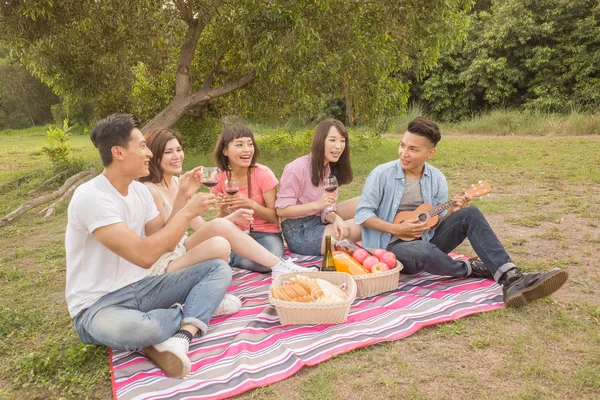 Asian people take a picnic with wine