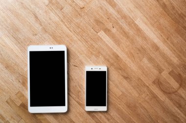 Smartphone ve tablet kimse ile ahşap masa