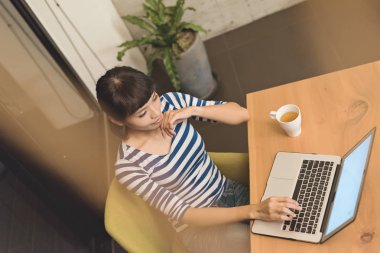 Asyalı kadın geceleri, evde çalışma konsept dizüstü bilgisayar kullanarak