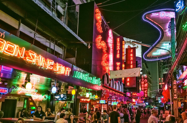 Bangkok, Thailand - Feb 16, 2017: crowded street Soi Cowboy at night, a famous red-light area, one of centers of prostitution and sex tourism in Bangkok city.