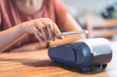 NFC teknolojisi ile bir akıllı telefon tarafından ödeme kadın