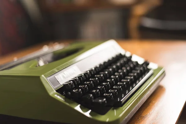 vintage typewriter in green color on the desk