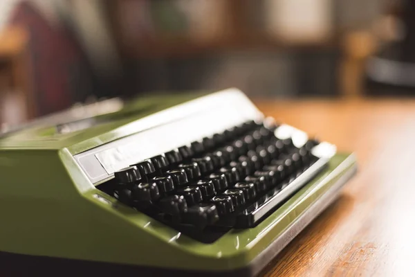 vintage typewriter in green color on the desk