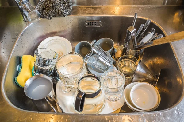 dirty dishes in the kitchen sink at home