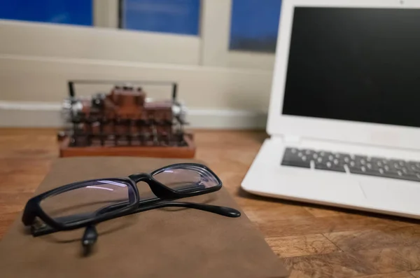 working at home with laptop on the wooden table in the night