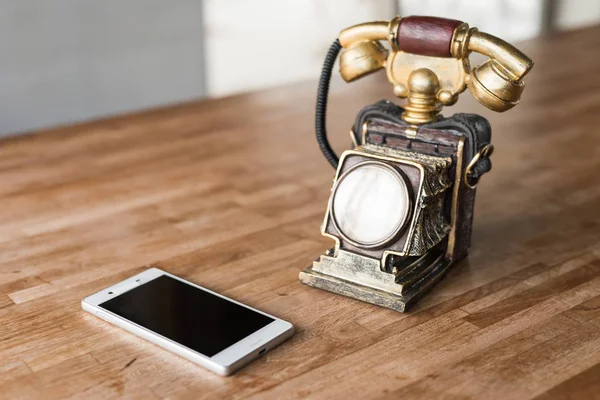 new and old telephone on the wooden desk