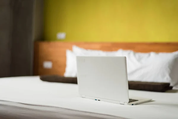 laptop on the bed, concept of working at home