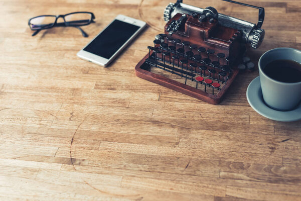 vintage typewriter on the wooden table with copyspace