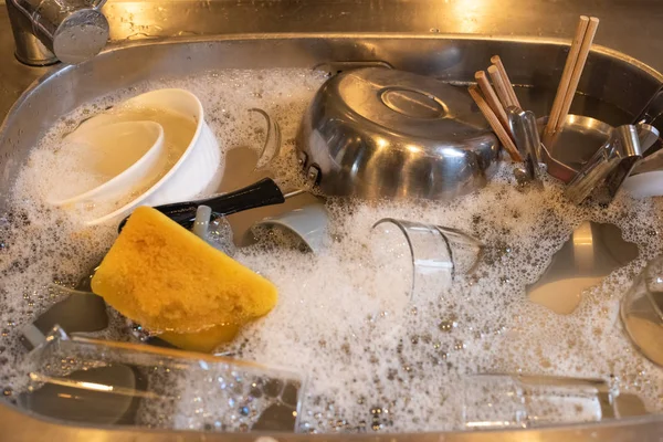 dirty dishes in the kitchen sink at home