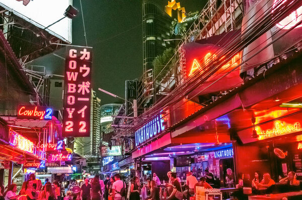 Bangkok, Thailand - Feb 16, 2017: crowded street Soi Cowboy at night, a famous red-light area, one of centers of prostitution and sex tourism in Bangkok city.