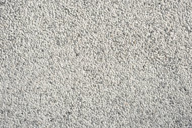 Duvardaki küçük kaya veya taşlar, gri arkaplan