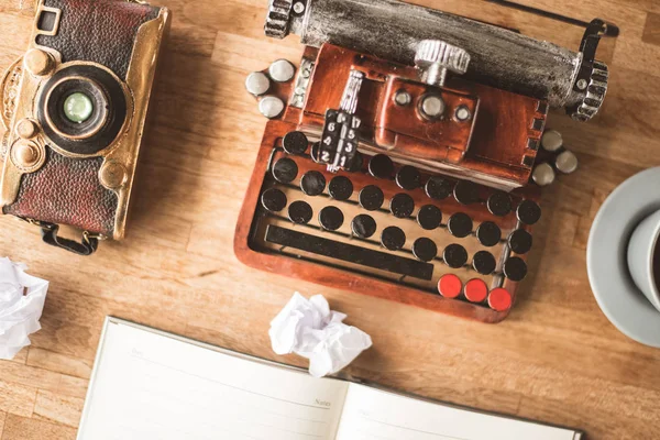 blank note book with typewriter on the desk at home