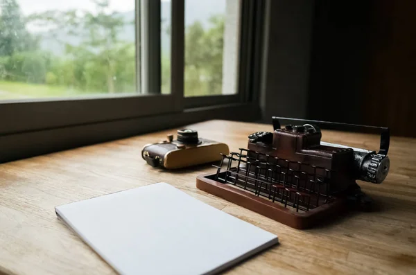 blank note book with typewriter on the desk at home