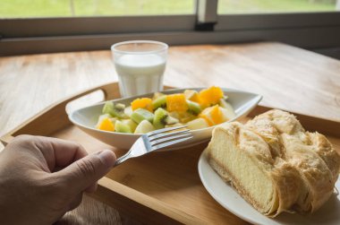 Sabah kahvaltıda süt, meyve ve kek.