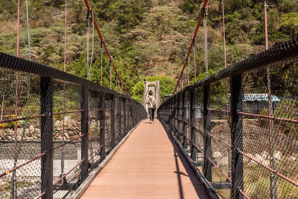 Frau läuft auf Hängebrücke — Stockfoto