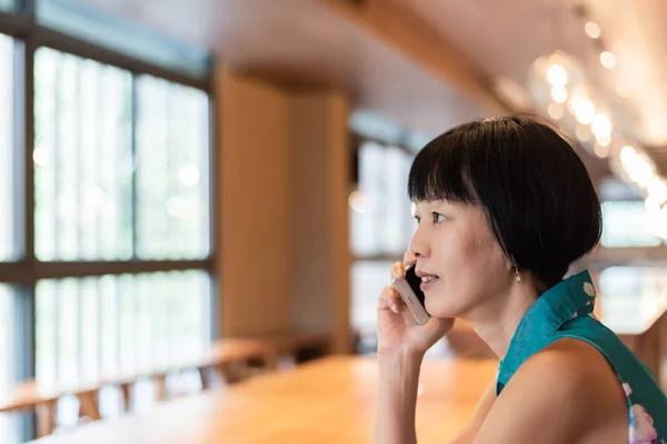 Kobieta rozmawiać na telefon komórkowy w kawiarni — Zdjęcie stockowe