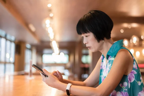 Charla de la mujer en el teléfono celular en una cafetería — Foto de Stock