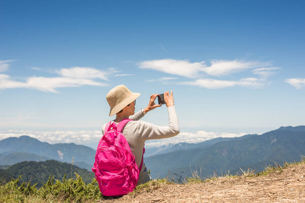 Asian climbing woman take pictures at Hehuan mountain, Taiwan