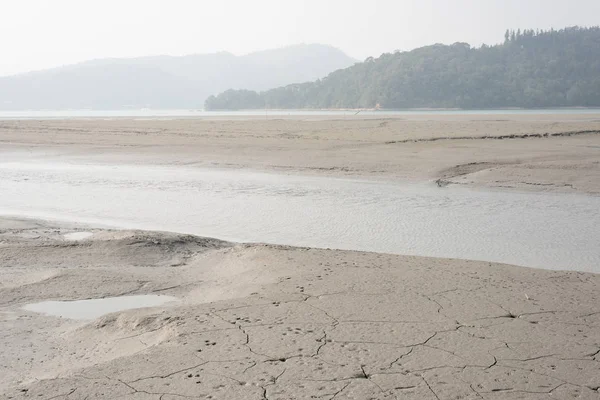 Dry mud landscape with water — Stock Photo, Image