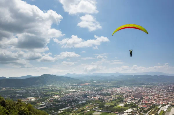 Colorful paragliding over blue sky at town — Stock Photo, Image