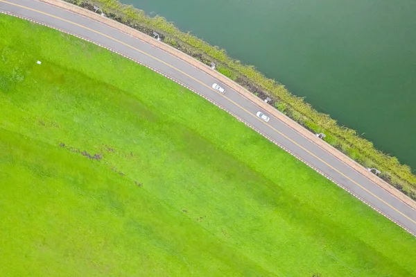Landschap van de weg met grasland in de buurt van het meer — Stockfoto
