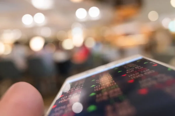 Een mobiel apparaat gebruiken om marktgegevens te controleren — Stockfoto