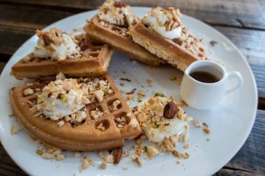 Ahşap masadaki bir tabakta nefis waffle.