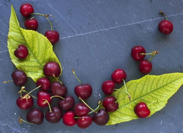 Cherries on slate slab — Stock Photo, Image
