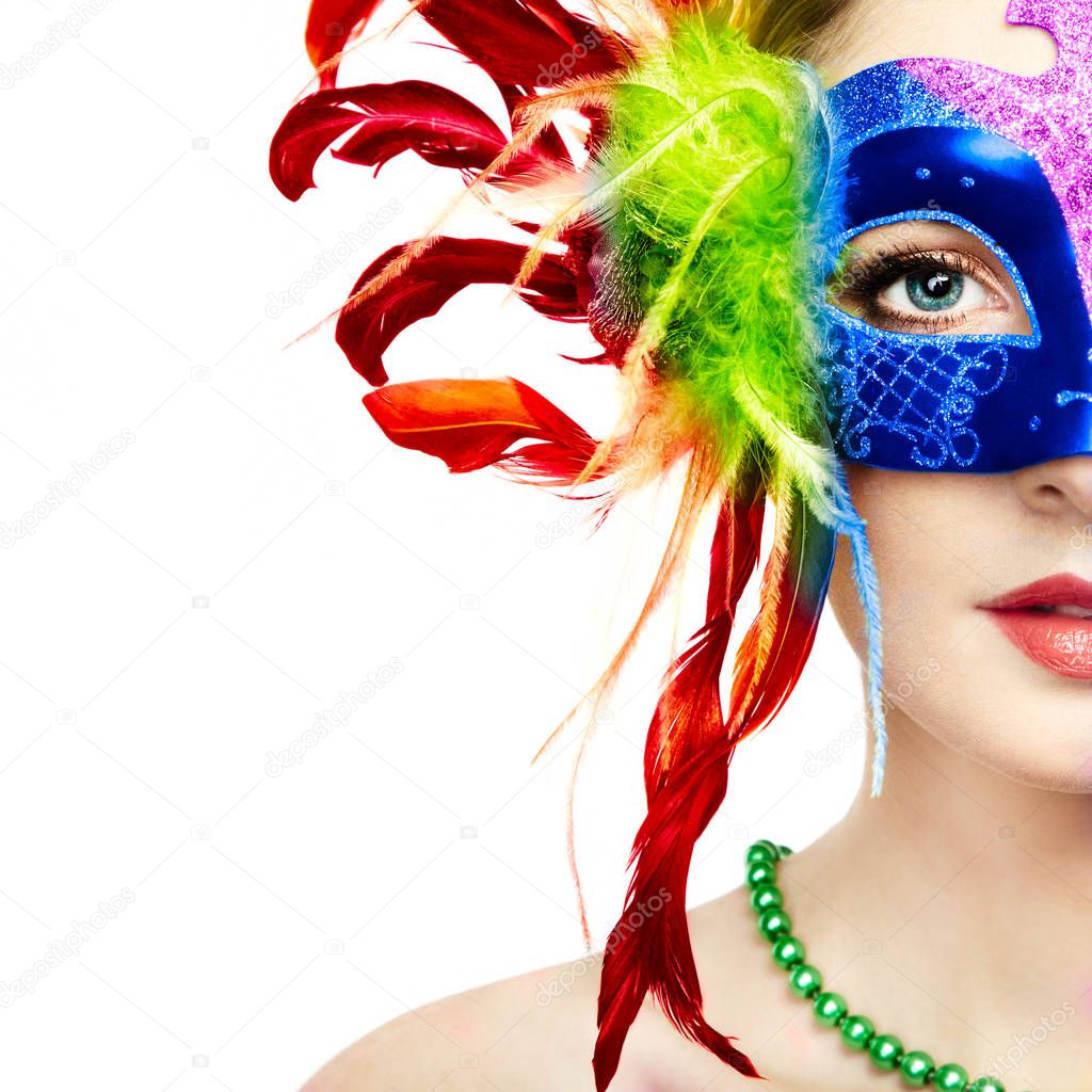 Beautiful young Woman in Mysterious Rainbow Venetian Mask. Fashion photo. Masquerade Mask with Colour Feathers